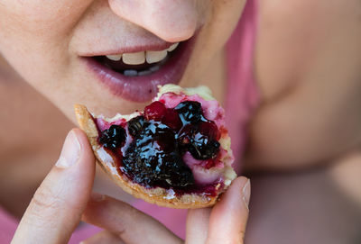 Close-up of woman eating tart