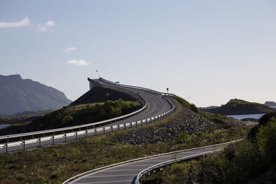 High angle view of vehicles on road by mountain against sky