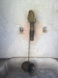 Close-up of faucet against wall