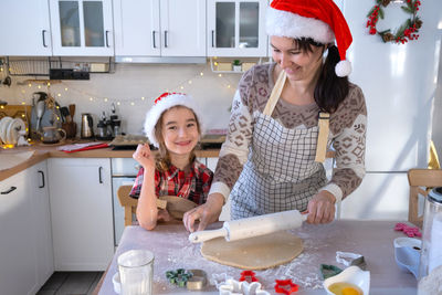 Portrait of smiling friends in kitchen