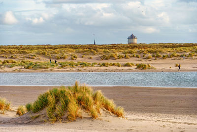 The water tower of the village of monster seen over the dunes from the zandmotor beach