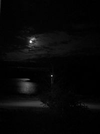 Illuminated landscape against sky at night