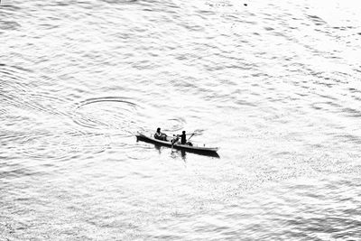 Man rowing boat on shore