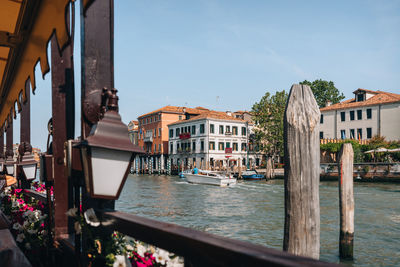 View from a waterside restaurant of a water taxi riding through grand canal in venice, italy.