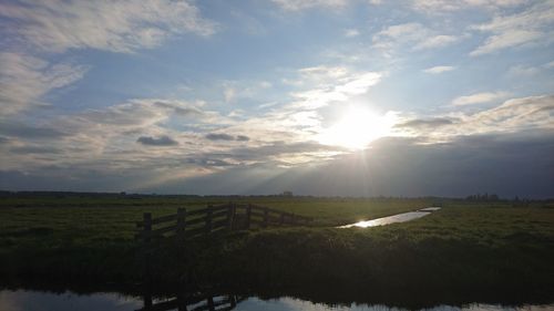 Scenic view of field against sky during sunset