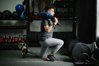 Attractive young athlete doing indoor workout.