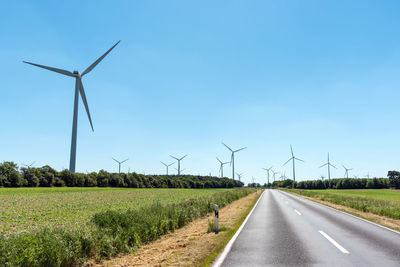 Wind power plants and a country road seen in germany