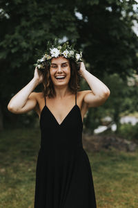 Happy woman wearing wreath of flowers