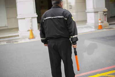 Rear view of man standing on street