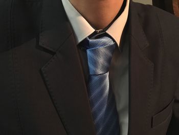 Midsection of man wearing suit