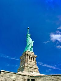 Low angle view of statue against blue sky