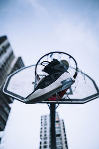 Low angle view of street light against building