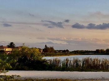 Scenic view of lake against sky during sunset