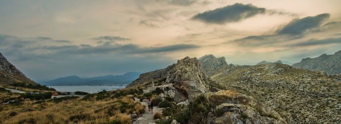 Scenic view of mountains against cloudy sky