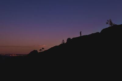 Silhouette mountains against clear sky during sunset