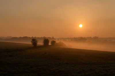 Scenic view of field against sky during sunset