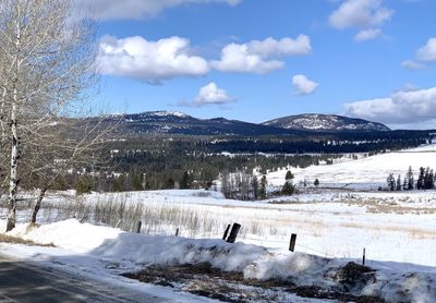 Scenic view of snow covered mountains against sky