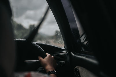 Close-up of hand on car window