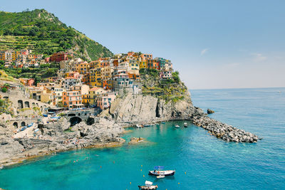 Panoramic view of sea and buildings against sky