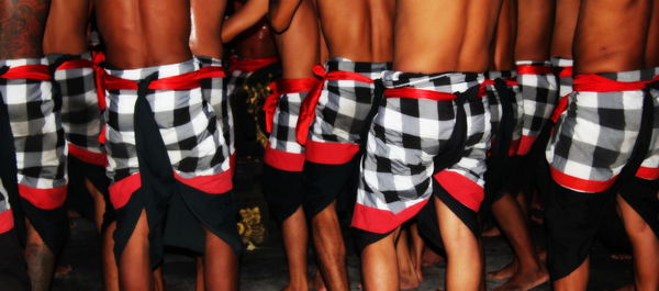 Rear view of men performing kecak dance