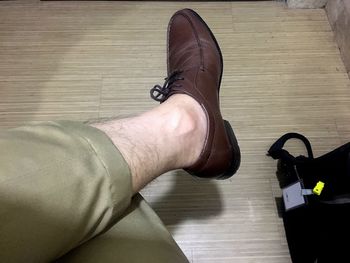 Low section of man wearing shoes