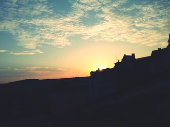 Built structure against sunset sky