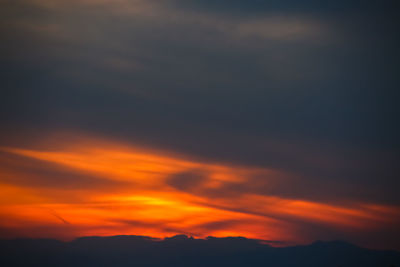 Low angle view of dramatic sky during sunset