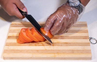 Close-up of person preparing food on cutting board