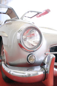Detail of a classic car with wing doors with borders disappearing into the bright light