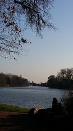 Scenic view of lake against clear sky during sunset