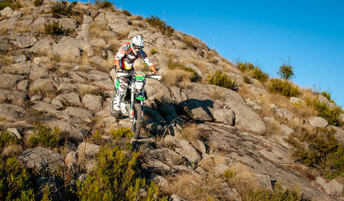 Man riding bicycle on rock