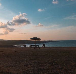 Scenic view of beach against sky during sunset