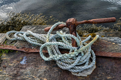 High angle view of rope tied on pier