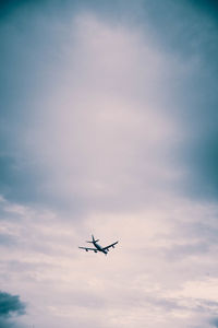 Low angle view of airplane flying in sky