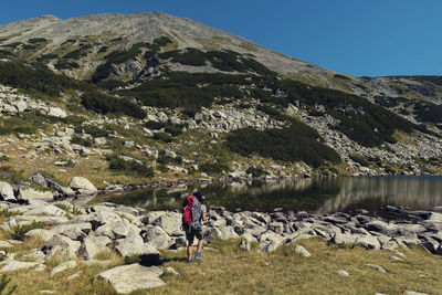 Woman hiking on land during summer