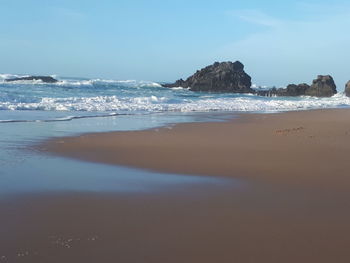 Scenic view of beach against sky