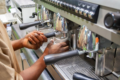 Midsection of person working in kitchen