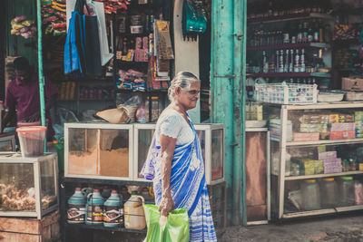 Woman standing at market stall