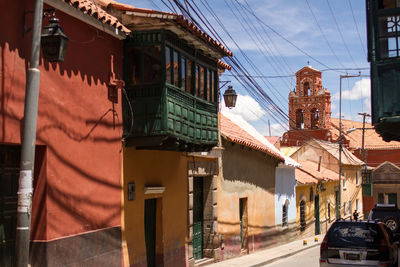 Cars on street amidst buildings in town