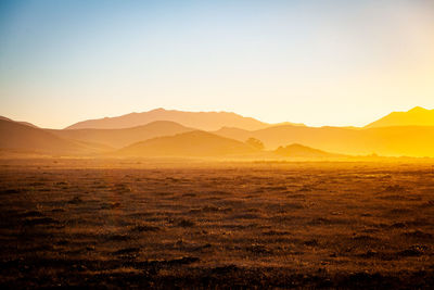 Scenic view of landscape against sky during sunset