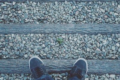 Directly above shot of shoes on footpath