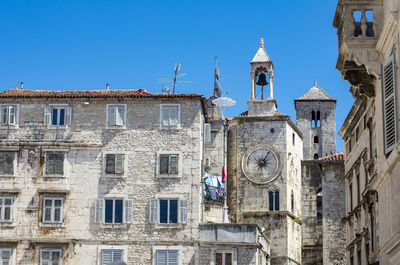 Low angle view of historic building against clear blue sky