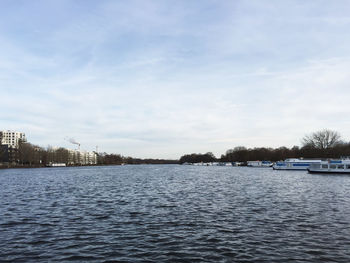 Scenic view of river against sky during winter