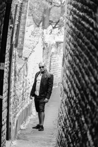 Full length portrait of man standing amidst walls