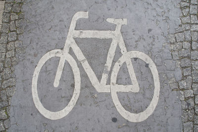 Close-up of bicycle sign on road