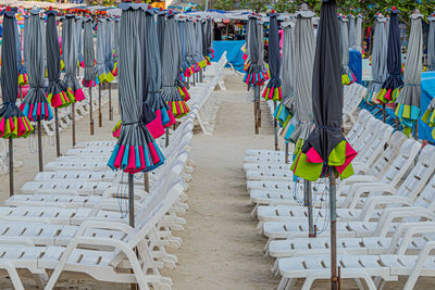 Empty chairs in row at beach