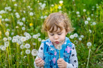 Portrait of girl playing with flowers