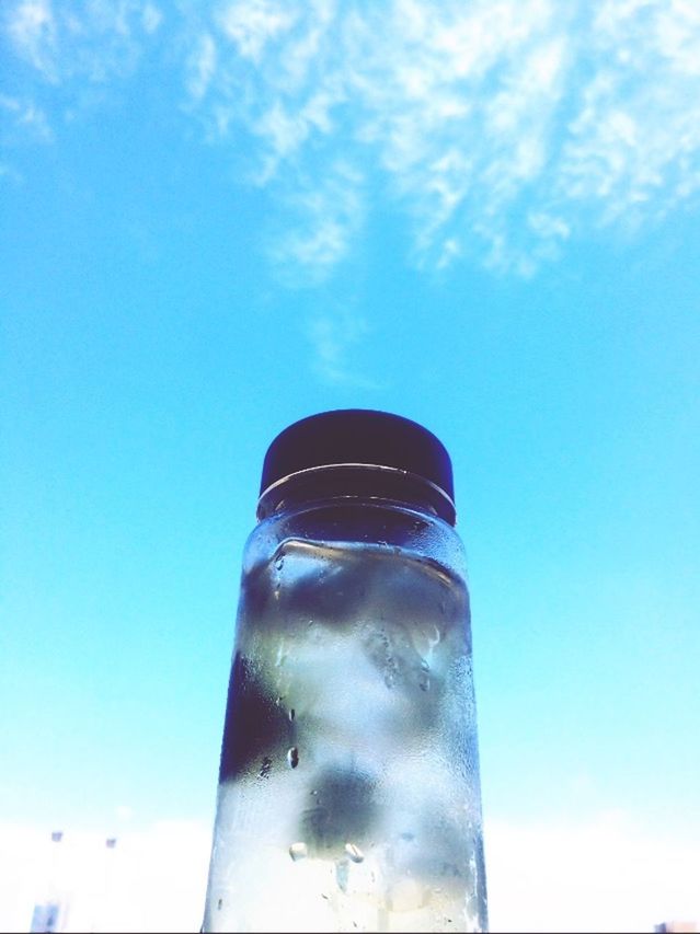 blue, low angle view, sky, cloud - sky, cloud, glass - material, reflection, day, outdoors, close-up, no people, sunlight, modern, built structure, refreshment, tall - high, cloudy, transparent, architecture, tower