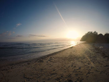 Scenic view of beach against sky during sunset