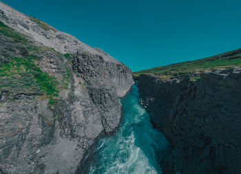 Scenic view of mountains against clear blue sky